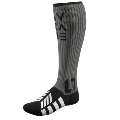A single knee-high athletic sock in gray and black with a ribbed texture, featuring a stylized logo on the leg and three white stripes on the toe, shown against a light gray background.