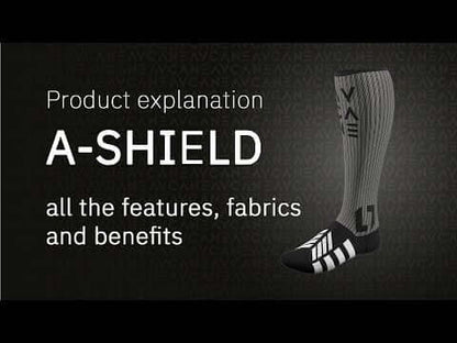 Product explanation graphic for the A-Shield sock, showing a single ribbed knee-high sock with black and white stripes and branding on a dark textured background with text reading 'Product explanation A-SHIELD all the features, fabrics and benefits'.