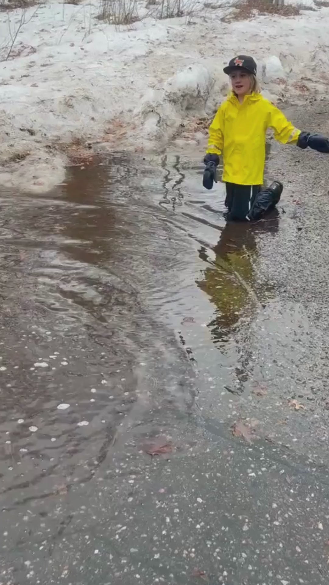 Load video: Child playing in rain puddles