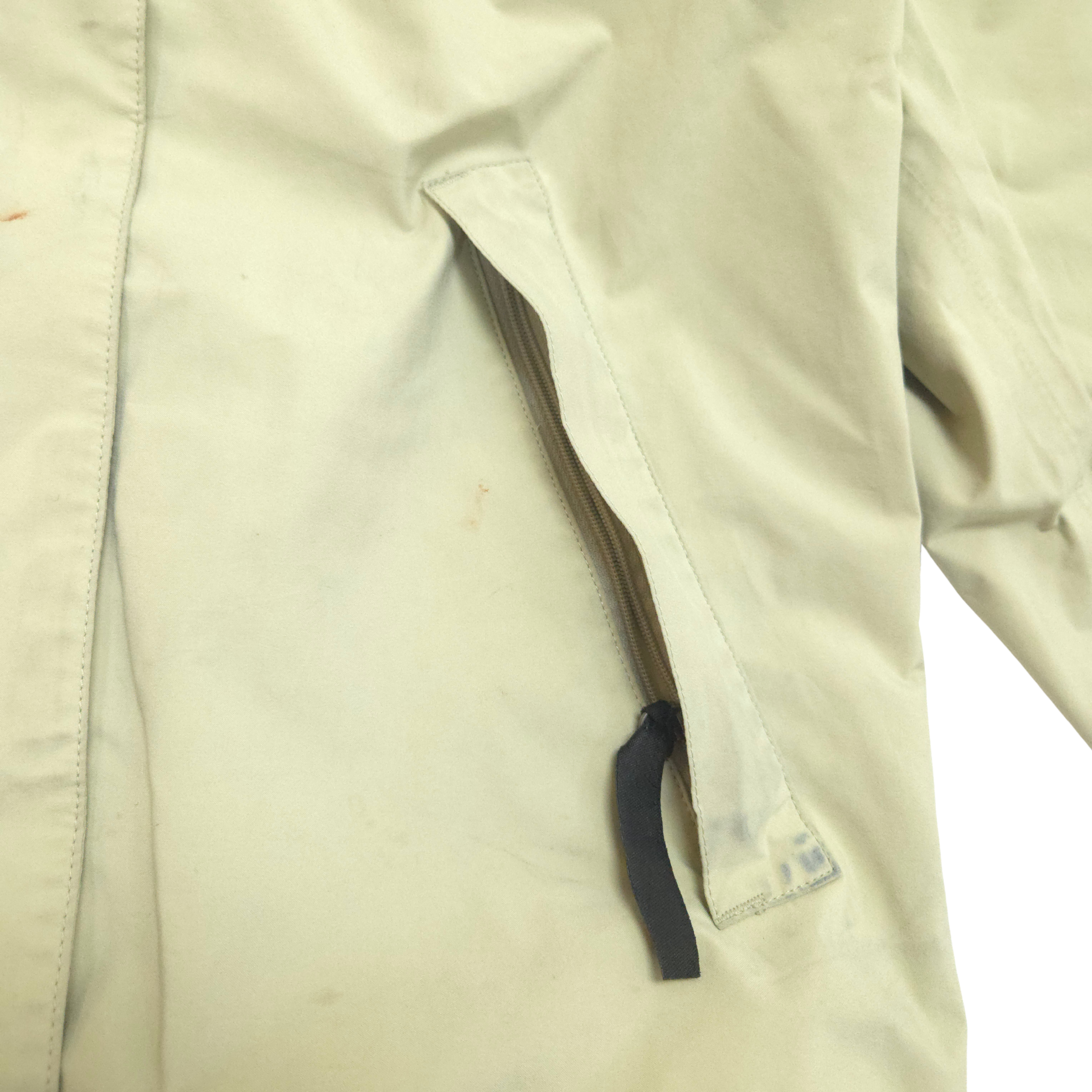 Close-up of a beige jacket with a zippered packet